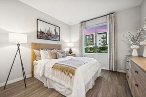 Glendale apartment for rent - Model Bedroom with Wood-Style Flooring and Window View at Glen 91 Apartments located in Glendale, AZ.