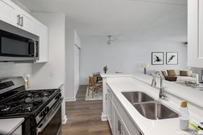 Alexandria apartment for rent - Model, modern kitchen with a stove top oven and white cabinets.