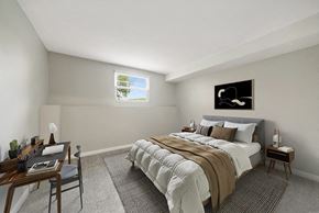 Marlborough apartment for rent - One-Bedroom Apartments in Marlborough, MA - Meadows at Marlborough - A Bedroom With Neutral Bedding, Desk Workspace, Soft Carpet, And Bright Window Lighting.