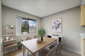 Renton apartment for rent - Model Dining Room with Carpet and Window View at Grammercy Apartments located in Renton, WA.