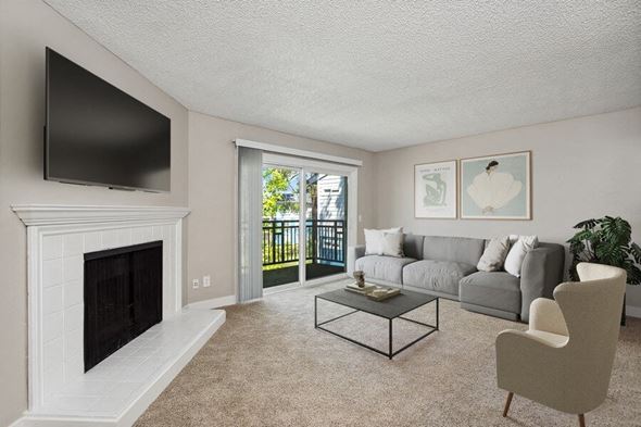 Sacramento apartment for rent - Model living room with a fireplace and a sliding glass door