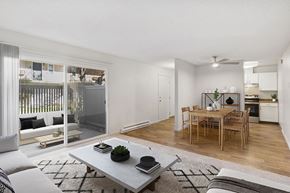 San Jose apartment for rent - Model Living Room with Carpet, View of Dining Area, and Patio Accessibility at Los Gatos Landing Apartments located in San Jose, CA.