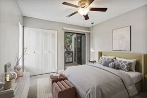 Sarasota apartment for rent - Model Bedroom with Carpet and Patio Accessibility at Huntington Place Apartments located in Sarasota, FL.