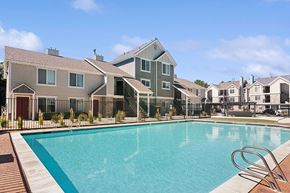 West Jordan apartment for rent - Community Swimming Pool with Pool Furniture at Broadmoor Village Apartments located in West Jordan, UT.