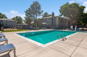 Salt Lake City apartment for rent - Community Swimming Pool with Pool Furniture at Overlook Apartments located in Salt Lake City, UT.