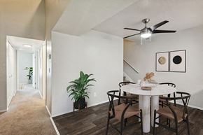 West Jordan apartment for rent - Model Dining Room with Wood-Style Flooring & View of Hallway at Broadmoor Village Apartments in Salt Lake City, UT.