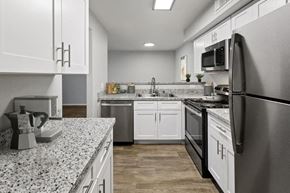 Tucson apartment for rent - Model kitchen showcasing stainless steel appliances.