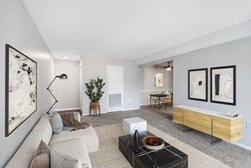 Gaithersburg apartment for rent - a living room with a white couch and a table