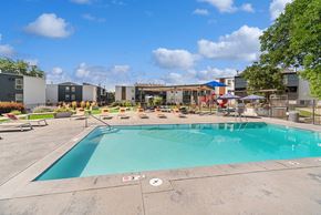 Lakewood apartment for rent - Community Swimming Pool with Pool Furniture at Waterfront Apartments in Lakewood, CO.