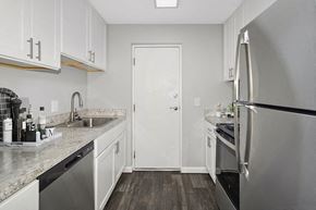 Stoughton apartment for rent - Model Kitchen with White Cabinets and Wood-Style Flooring at Stone Ends Apartments in Stoughton, MA.