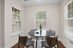 Charlotte apartment for rent - Model Dining Room with Wood-Style Flooring at Park at Caterina Apartments located in Charlotte, NC.