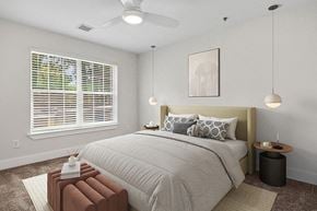 Charlotte apartment for rent - Model Bedroom with Carpet and Window View at Park at Caterina Apartments located in Charlotte, NC.