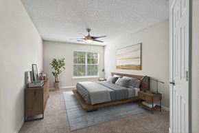 Lithonia apartment for rent - Model Bedroom with Carpet and Window View at Retreat at Stonecrest Apartments located in Lithonia, GA.