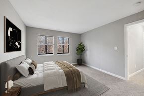Raleigh apartment for rent - Model Bedroom with Carpet and Hallway View at Spring Forest Apartments in Raleigh, NC.