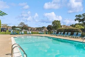 Marlborough apartment for rent - 2-Bedroom Apartments in Marlborough, MA - Meadows at Marlborough - Outdoor Swimming Pool With Clear Blue Water, Sundeck Lounge Chairs, Green Umbrellas, And Fenced Courtyard.