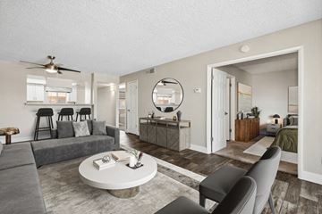 Phoenix apartment for rent - Model apartment living room with a couch a coffee table and a kitchen