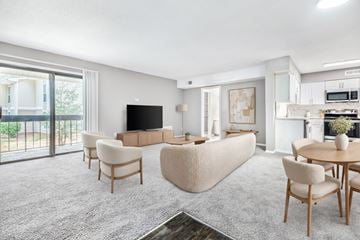 Raleigh apartment for rent - A living room with a grey carpet and wooden furniture.