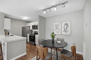 Orlando apartment for rent - Model Dining Room and Kitchen Area with Wood-Style Flooring at Fountains Lee Vista Apartments in Orlando, FL.
