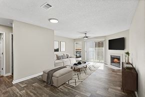 Marietta apartment for rent - Model Living Room with Wood-Style Flooring, Fireplace and Patio Accessibility at Element 41 Apartments located in Marietta, GA.