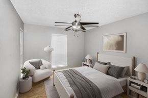 Arlington apartment for rent - Model bedroom with a bed and a ceiling fan