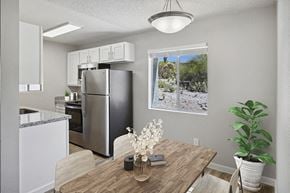 Tucson apartment for rent - Model Dining Room with Wood-Style Flooring & View of Kitchen at Hilands Apartments in Tucson, AZ.
