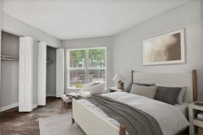 Charlotte apartment for rent - Model Bedroom with Double Closets and Wood-Style Flooring at Arbor Village Apartments in Charlotte, NC.