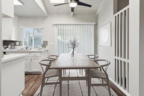 El Cajon apartment for rent - Model Dining Room and Kitchen Area with Wood-Style Flooring and Patio Accessibility at Colonnade at Fletcher Hills Apartments in El Cajon, CA.