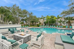 Sarasota apartment for rent - Outdoor Fire Pit Area and Swimming Pool with Lounge Furniture at Huntington Place Apartments located in Sarasota, FL.