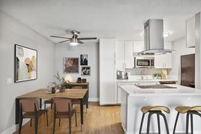 La Mesa apartment for rent - Model Kitchen with White Cabinets and Wood-Style Flooring at Cove La Mesa Apartments located in La Mesa, CA.