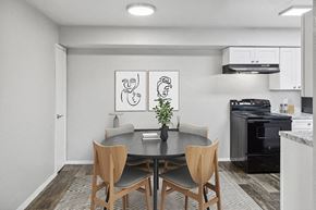Tucson apartment for rent - Model Dining Room with Wood-Style Flooring and View of Kitchen at Tanque Verde Apartments located in Tucson, AZ.