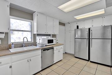 Victorville apartment for rent - A kitchen with white cabinets and appliances.