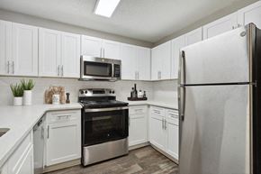 Lithonia apartment for rent - Model kitchen with stainless steel appliances at Retreat at Stonecrest Apartments