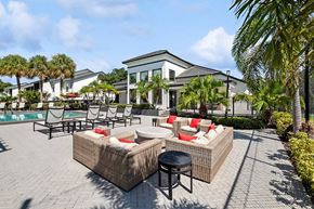 Orlando apartment for rent - Outdoor Lounge Area with Furniture and View of Pool at Rosehill Preserve Apartments in Orlando, FL.