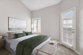 Phoenix apartment for rent - Model Bedroom with Carpet and Patio Accessibility at Crystal Creek Apartments in Phoenix, AZ.
