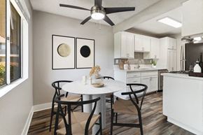 El Cajon apartment for rent - Model Dining Room with Wood-Style Flooring, One Window & View of Kitchen at Forest Park Apartments in El Cajon, CA.