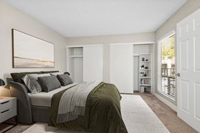 Phoenix apartment for rent - Model apartment bedroom with a large bed and a large window at Villages at Metro Center, Arizona