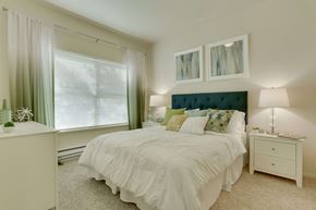 Gresham apartment for rent - Model Bedroom with Carpet and Window View at Landings at Morrison Apartments located in Gresham, OR.
