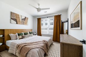 Aurora apartment for rent - A bedroom with a large bed and a wooden headboard.
