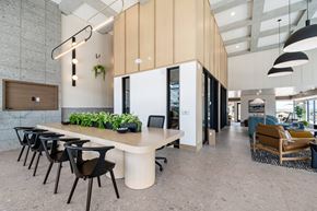 Aurora apartment for rent - A modern office space with a long table and chairs.