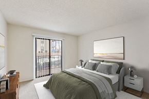 Marietta apartment for rent - Two-Bedroom Luxury Apartments in Marietta, GA - The Grandstand - A Bedroom With A Made Bed, Neutral Decor, Nightstands With Lamps, And Sliding Glass Doors.