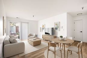 Aurora apartment for rent - Model living room with a couch, chairs, and a coffee table.