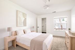 Aurora apartment for rent - Model bedroom with a bed, nightstand, and a painting on the wall.