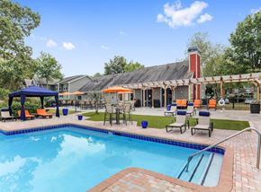 Marietta apartment for rent - Two-Bedroom Apartments in Marietta, GA - Laurel Hills Preserve - A Swimming Pool With Blue Water, Lounge Chairs, Cabana Canopy, Patio Tables With Umbrellas, And A Clubhouse.