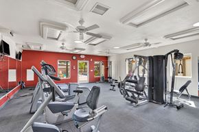Victorville apartment for rent - A gym with a variety of equipment including treadmills, weights, and exercise machines.