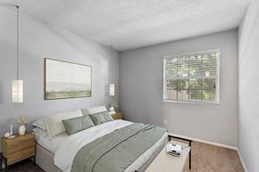 Peachtree Corners apartment for rent - Three-Bedroom Affordable Apartments in Peachtree Corners, GA - Corners At 1700 - Bright Bedroom With Plush Bed, Pendant Lighting, Wood Nightstands, And A With Window Blinds.