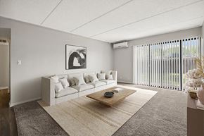 Burnsville apartment for rent - Pet-Friendly Affordable Apartments in Burnsville, MN - Elevate on Parkway - A Living Room With Sofa, Low Coffee Table, Soft Area Rug, And Wall Art.