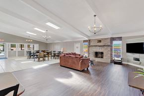 Victorville apartment for rent - A spacious living room with a fireplace and a couch.