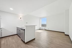 Aurora apartment for rent - A kitchen with white cabinets and a wooden floor.