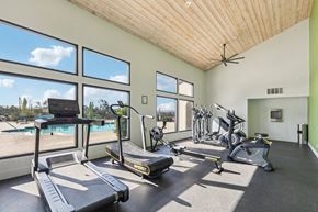 Carlsbad apartment for rent - A gym with treadmills, exercise bikes, and a fan.