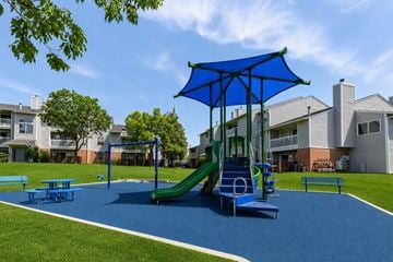 Aurora apartment for rent - A playground with a blue umbrella and slide.